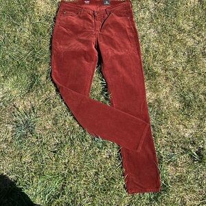 AG  rust colored narrow corduroy “Prima Cigarette Leg” pants